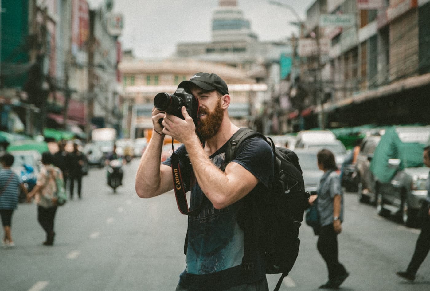 A photographer shooting on a crowded street