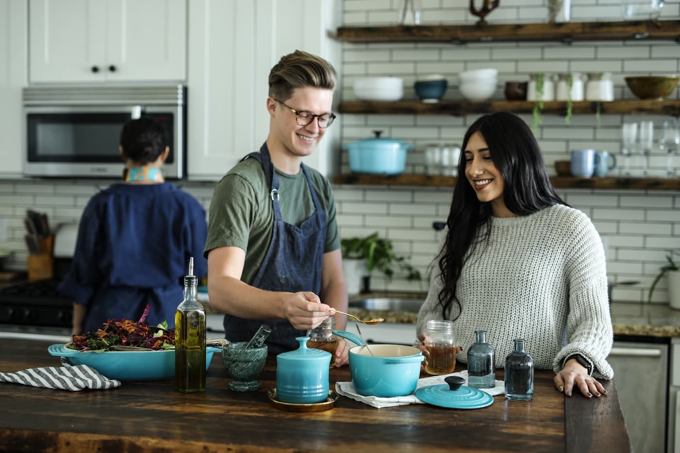 Two creators cooking together at a kitchen counter