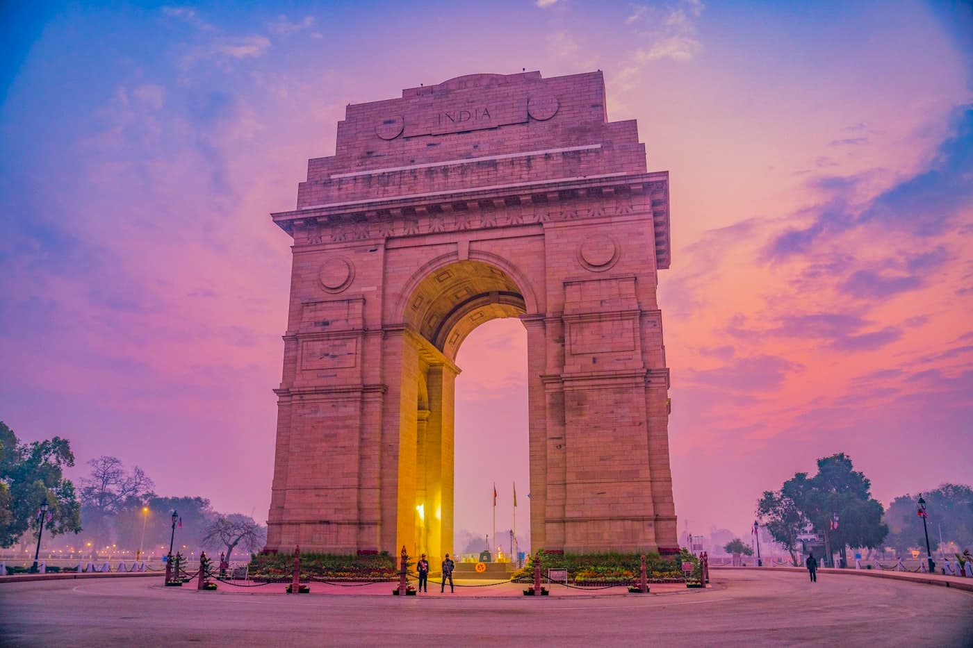 India Gate in Delhi under a pink and violet dusk sky