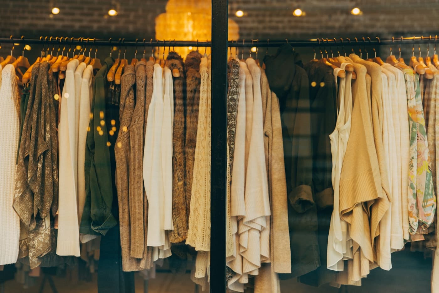 A boutique rail of shirts and jackets under warm light
